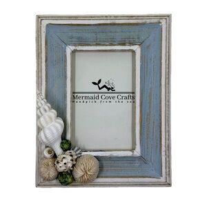 Rustic blue and white picture frame with seashells, perfect for coastal decor.